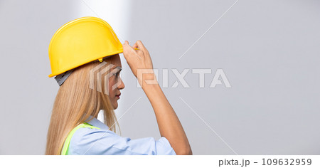 Female worker blonde hair lost her fingers from injured accident in industrial job. Woman engineer wear yellow hard hat show her lost fingers from work and insurance. White background isolated Female worker blonde hair lost her fingers from injured accident in industrial job. Woman engineer wear yellow hard hat show her lost fingers from work and insurance. White background isolated 109632959