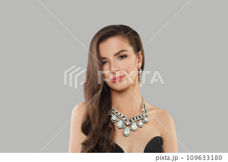 Glamorous jewelry woman brunette fashion model with gold diamond earning and luxury necklace posing Glamorous jewelry woman brunette fashion model with gold diamond earning and luxury necklace posing 109633180