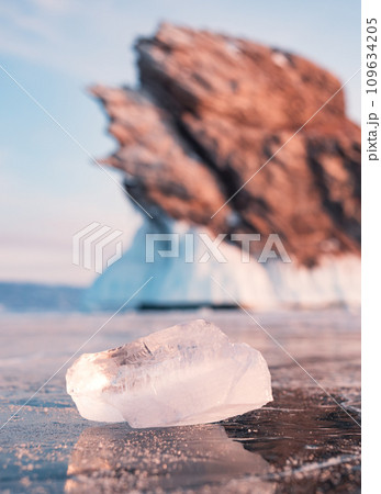 Ogoy island on winter Baikal lake. Winter scenery of Dragon Tail Rock on Ogoy island during sunrise at Lake Baikal. 109634205