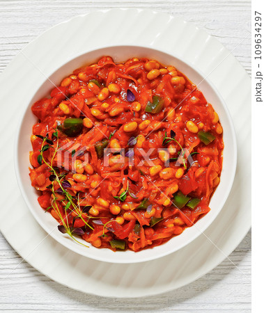 chakalaka, spicy tomato bean relish in white bowl 109634297