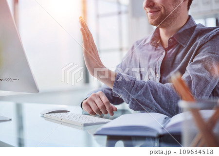 Happy businessman connecting with his team online Happy businessman connecting with his team online 109634518