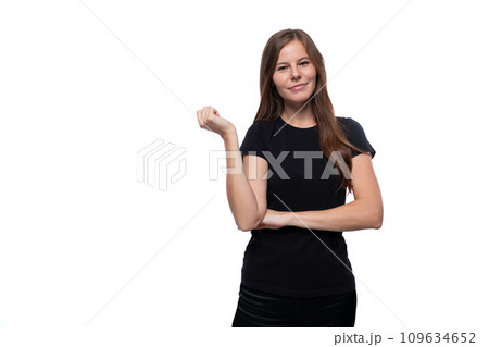 Dreamy young woman with straight hair wearing a black T-shirt on a white background 109634652