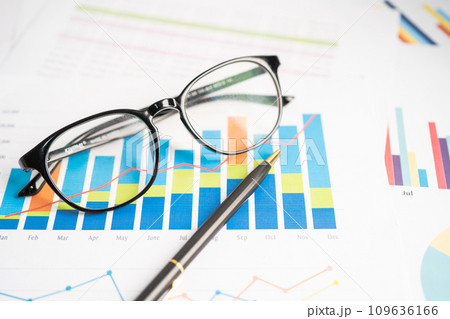 Eyeglass on chart graph paper. Finance, account, statistic, investment data economy, stock exchange business. 109636166