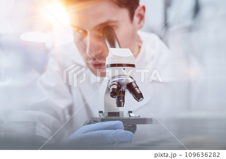 close up. the scientist looks through the microscope close up. the scientist looks through the microscope 109636282