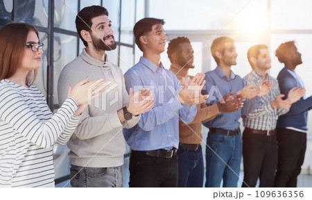 Close up side profile, different participants business people stand and express appreciation by clapping their hands Close up side profile, different participants business people stand and express appreciation by clapping their hands 109636356