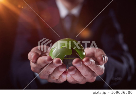 man holding a small green glass ball, generative ai 109636380