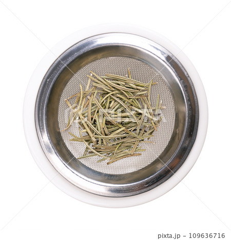 Dried rosemary leaves on the sieve of an incense burner, from above. Salvia rosmarinus, an aromatic and evergreen shrub, with fragrant needle-like green leaves, used for cleansing and purifying air. Dried rosemary leaves on the sieve of an incense burner, from above. Salvia rosmarinus, an aromatic and evergreen shrub, with fragrant needle-like green leaves, used for cleansing and purifying air. 109636716