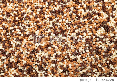 Chocolate mini pearls, background. Extra crunchy sprinkles, made of grain extrudate, covered with white, milk and dark chocolate. Used as sweet decoration and topping for cookies, cakes and ice cream. Chocolate mini pearls, background. Extra crunchy sprinkles, made of grain extrudate, covered with white, milk and dark chocolate. Used as sweet decoration and topping for cookies, cakes and ice cream. 109636720