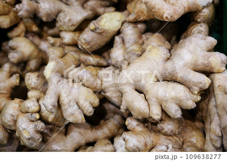 a lot of ginger in the store . A lot of Ginger Root. ginger harvest. ginger root food background. a lot of ginger in the store . A lot of Ginger Root. ginger harvest. ginger root food background. 109638277