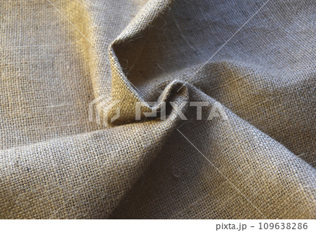 Yellow coiled yellow matter. A piece of burlap. The material for the bags. 109638286