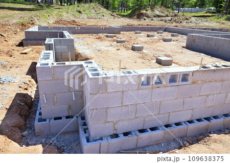 Foundation of concrete blocks has been constructed at construction site to support wall of house Foundation of concrete blocks has been constructed at construction site to support wall of house 109638375