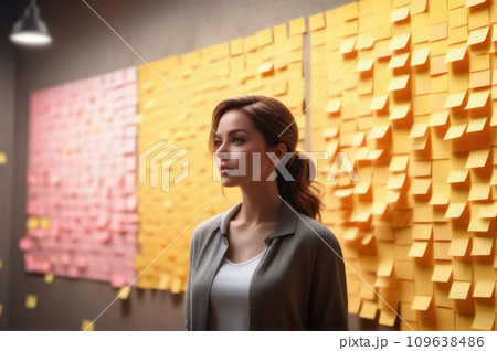 A woman standing in front of a wall full of colorful sticky notes. Young woman working in office and use post it notes to share idea. Communicating together in creative office. Brainstorming concept. 109638486