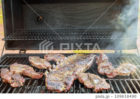 BBQ grill is used to hot smoke variety of juicy pork meats 109638490