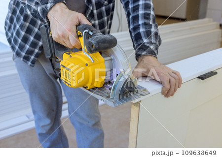 In order to install interior doors, they must be cut to desired size using manual circular saw 109638649