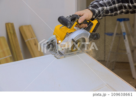 Using manual circular saw, interior doors must be cut to required size before installation 109638661