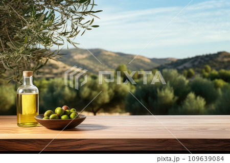 Old wooden product display table with natural green olive field and olive oil Old wooden product display table with natural green olive field and olive oil 109639084