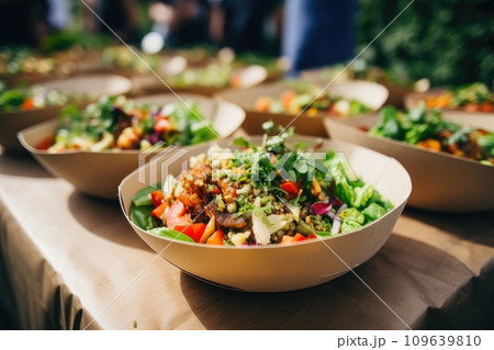 Street food festival, catering service. Vegetable salads in paper plates sold outdoors at market place 109639810