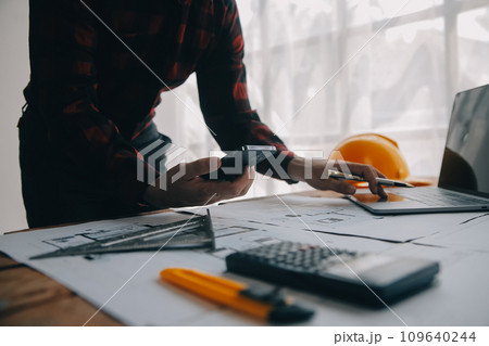 Two business man construction site engineer. Engineering objects on workplace with partners interacting on background 109640244