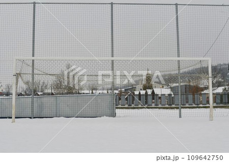 A snow-covered football goal. The concept of the end of the football season, the football league and the end of the sports season A snow-covered football goal. The concept of the end of the football season, the football league and the end of the sports season 109642750