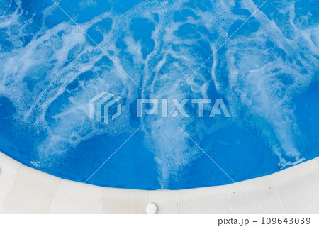 Air bubbles from jacuzzi jet in blue water in a pool Air bubbles from jacuzzi jet in blue water in a pool 109643039