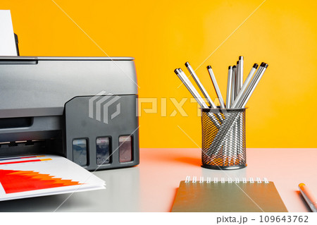 Laser printer on desk against yellow background. Laser printer on desk against yellow background. 109643762
