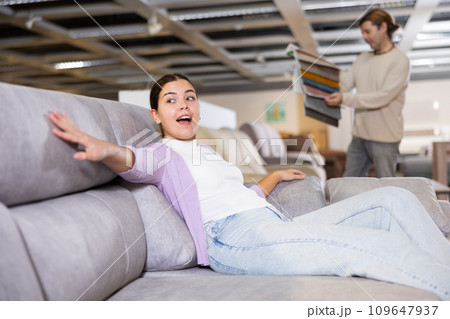Woman choosing armchair in furniture store Woman choosing armchair in furniture store 109647937