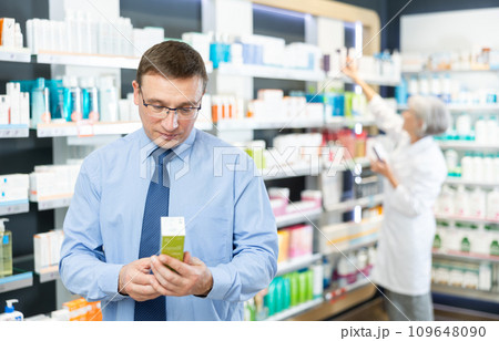 Middle-aged man client choosing convenient care product in box 109648090