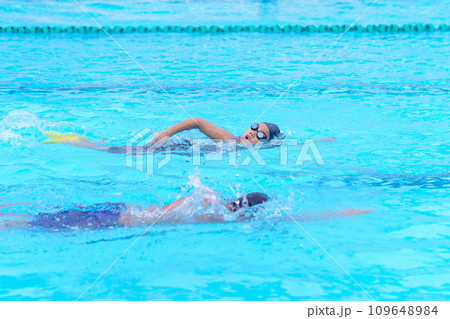 child swimmer swim in swimming pool. Water sports training and competition, learning to swim classes for children child swimmer swim in swimming pool. Water sports training and competition, learning to swim classes for children 109648984