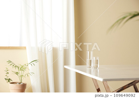 A cozy, bright room with sunlight streaming in. 109649092