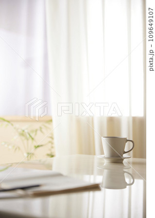 A cozy, bright room with sunlight streaming in. 109649107