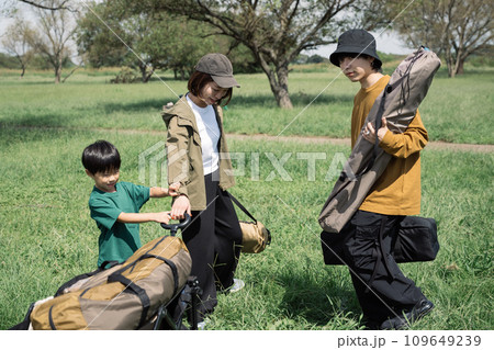 キャンプ・アウトドアカートから荷物を運ぶ家族イメージ 109649239