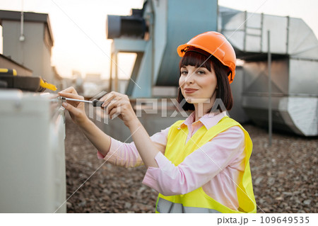 Focused female tightening bolt on cooling system outdoors Focused female tightening bolt on cooling system outdoors 109649535