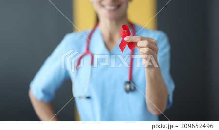 Doctor holding red ribbon in his hands closeup Doctor holding red ribbon in his hands closeup 109652496