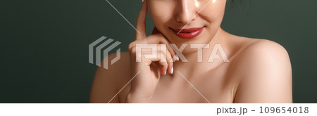 Young woman keeps eyes closed lips rounded touches 109654018