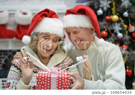 Happy elderly couple celebrating new year at home Happy elderly couple celebrating new year at home 109654034
