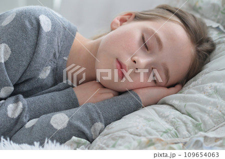 Sweet little girl sleeping in a bed Sweet little girl sleeping in a bed 109654063