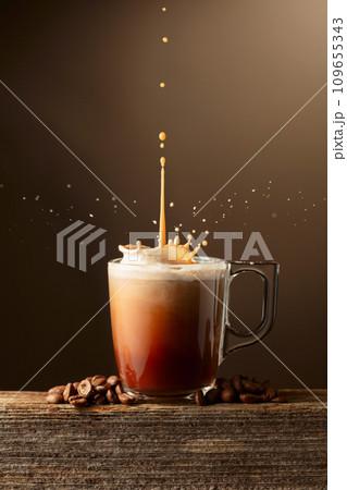 Coffee and chocolate drink with cream on a brown background. 109655343