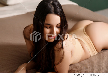 Beautiful sexy brunette woman lying. Perfect slim Beautiful sexy brunette woman lying. Perfect slim 109657097