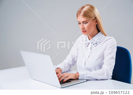Young businesswoman working at laptop computer. Young businesswoman working at laptop computer. 109657122