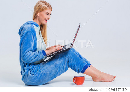 girl in pajamas with a laptop girl in pajamas with a laptop 109657159