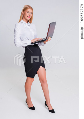 Young businesswoman working at laptop computer. Young businesswoman working at laptop computer. 109657179