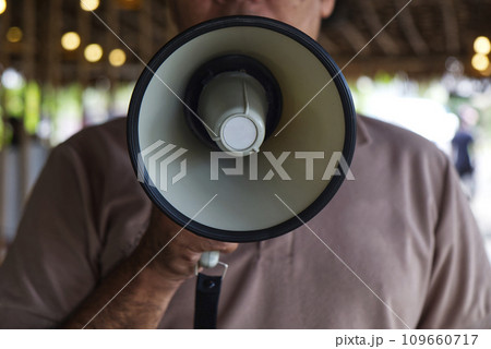 Man Using a Megaphone to Proclaim or Announcement Something with Very Loud Voice 109660717