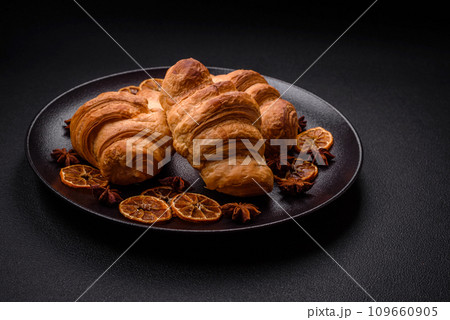 Delicious crispy baked sweet croissants with filling on a ceramic plate 109660905