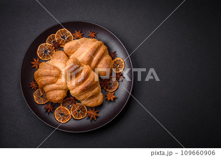 Delicious crispy baked sweet croissants with filling on a ceramic plate 109660906
