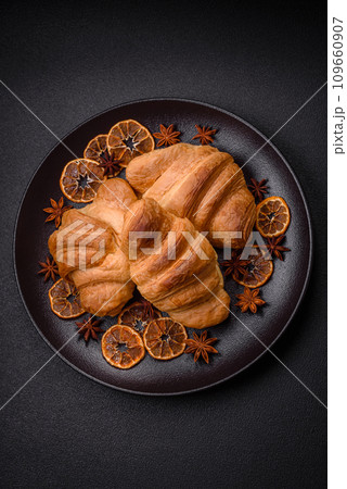 Delicious crispy baked sweet croissants with filling on a ceramic plate 109660907