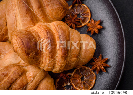 Delicious crispy baked sweet croissants with filling on a ceramic plate 109660909