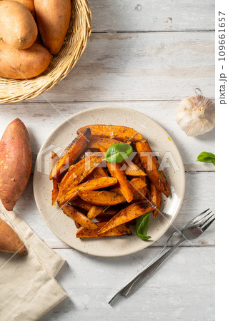 Delicious homemade sweet potato wedges, fries on a plate. 109661657