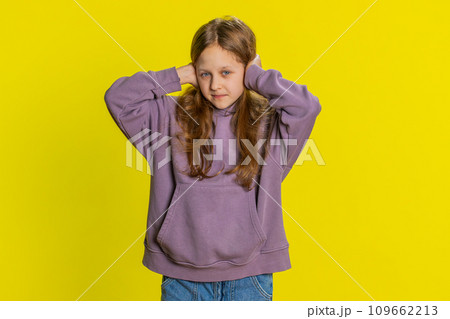 Frustrated young school girl kid covering ears ignoring unpleasant noise loud voices avoiding advice 109662213