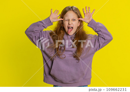 Cheerful funny bully child girl showing tongue making silly faces, fooling around, joking, teasing Cheerful funny bully child girl showing tongue making silly faces, fooling around, joking, teasing 109662231