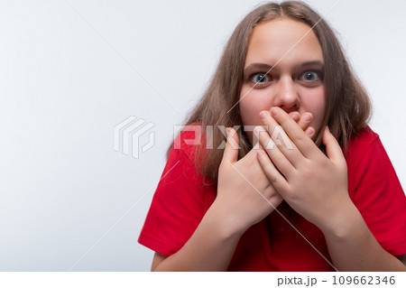 Headshot portrait of a European teenage girl with a surprised expression 109662346